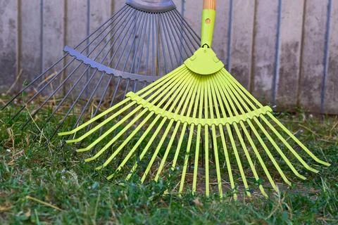 Two plastic mops sweeping trash garbage in the yard Stock Photos