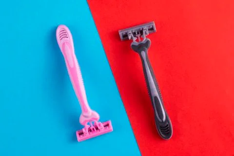 Two plastic razors on a two-color background close-up. Stock Photos