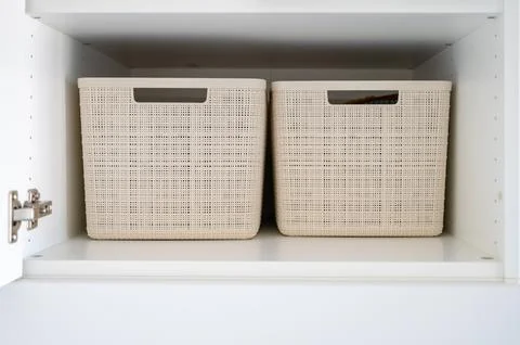 Two plastic storage boxes on shelf Stock Photos