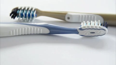 Two plastic toothbrushes rotating Video stock 144663196