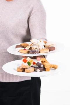 Two plates with assorted delicious looking traditional sweets being held by a Stock Photos