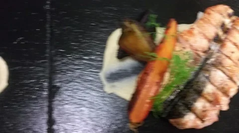 Two plates of broiled fried salmon dish, with cauliflower pure, carrot, golde Stock Footage 57676079