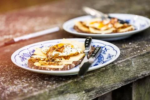 Two plates with fried egg on an old table Stock Photos
