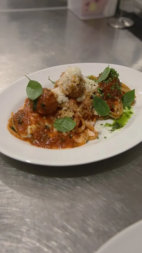 Two plates of pasta with meat sauce and cheese on the table. Stock Footage 311014640