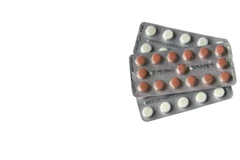 Two plates of yellow tablets on white isolated background Stock Photos