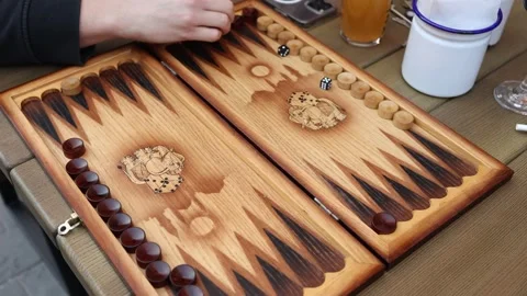 Two players enjoying outdoor backgammon session Stock Footage 307232045