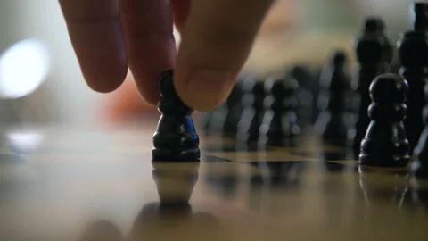 Two players move black and white pawn wooden chess pieces on checkerboard close  Stock Footage 145298827