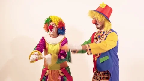 Two playing clowns having fun and trying to blow soap bubbles Stockbeeldmateriaal 70512702