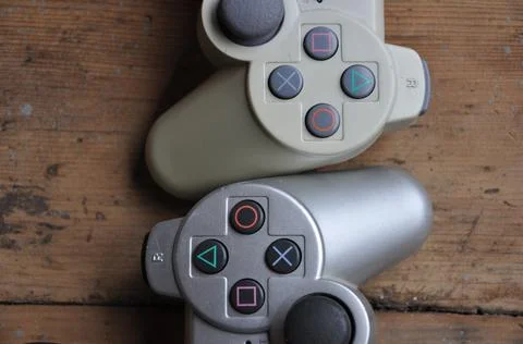 Two playstation console controllers with buttons Stock Photos