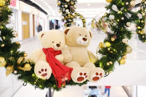 Two plush teddy bears adorned with festive scarves are nestled in a vibrant Stock Photos