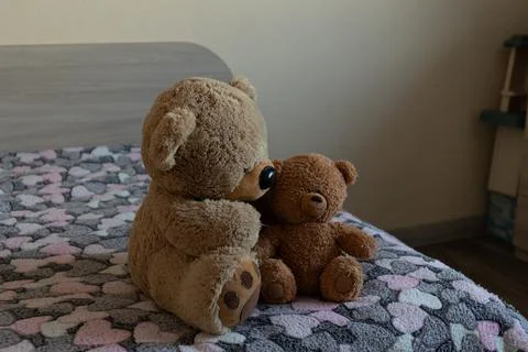 Two Plush Teddy Bears Embrace on Bed in Cozy Daylight Bedroom Scene Stock Photos