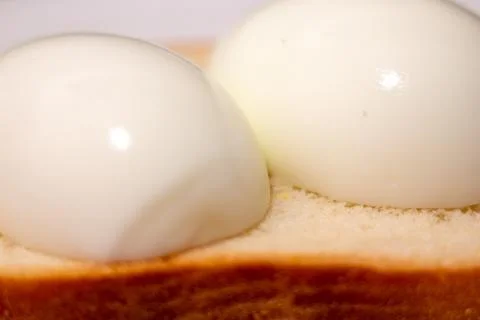 Two poached eggs on toasted bread for breakfast Stock Photos