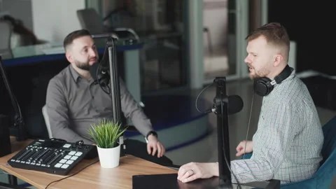 Two podcasters laughing and having fun in the studio. Two happy young people are Vidéo 240700716