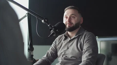 Two podcasters laughing and having fun in the studio. Two happy young people are Vidéo 240701020