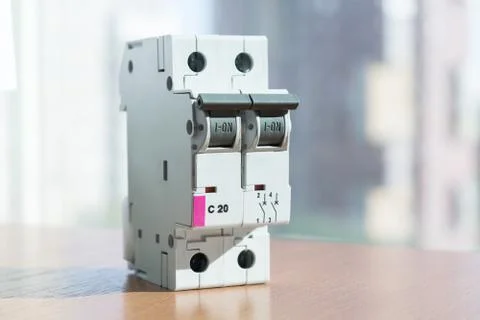 Two-pole modular circuit breaker is on the table, front view. Stock-Fotos