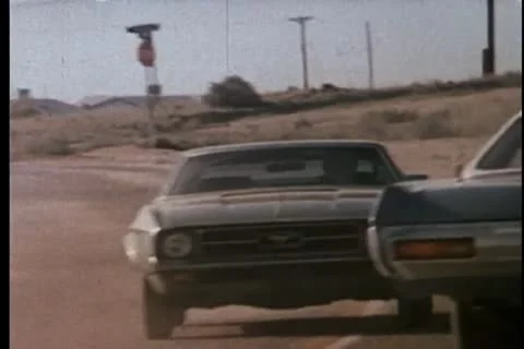 Two police cars on car chase in rural area Stock Footage