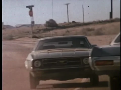 Two police cars on car chase in rural area Stock Footage