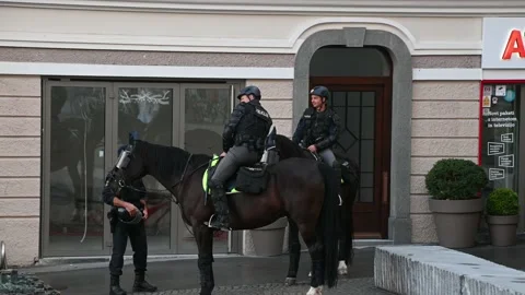 Two policeman mounted on horses during demonstrations in Ljubljana Stock Footage 135596411