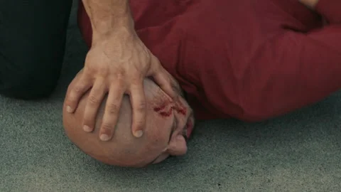 Two Policemen Arresting a bald criminal in the city and putting his head down Stock Footage 283062753