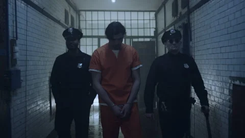 Two policemen taking prisoner to his cell Stock Footage 283090355