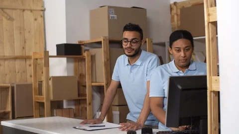 Two Polite Post Office Clerks Giving Parcel to Customer Stock Footage 114212737