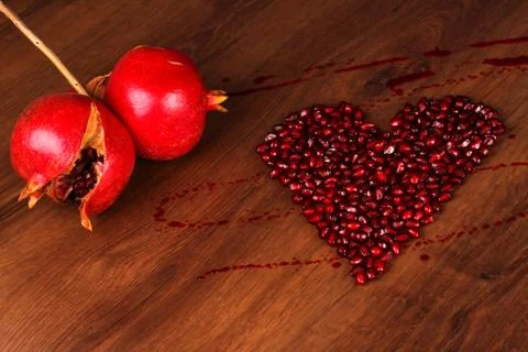 Two pomegranate and heart composition Stock Photos