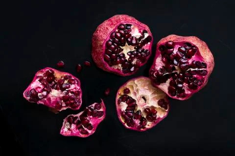 Two pomegranates on a black background Stock Photos