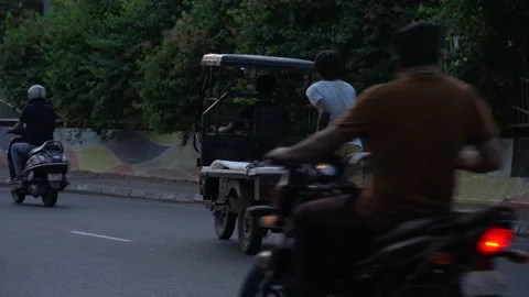Two poor kids running behind the battery rikshaw Stock Footage 210410082