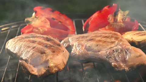 Two pork steaks are fried on bbq Stock Footage 139869210