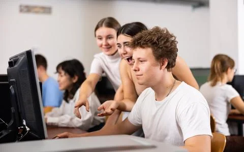Two positive classmates enjoying solving of task of computer science with male Stock Photos