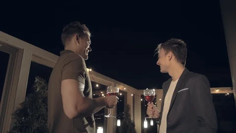 Two positive successful guys chatting during a rooftop party Stock Footage 116646599