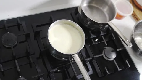 Two pots are on a stove top Stock Footage 305646879