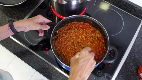 Two pots preparing macaroni bolognese Stock Footage 283276277