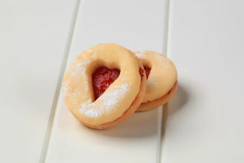 Two powdered donuts with strawberry jam filling Stock Photos