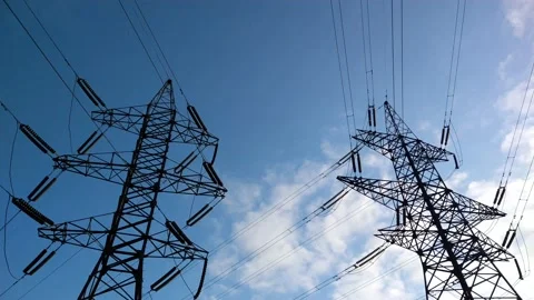 Two power lines under blue skies and fast moving white clouds.  b roll Stock Footage 161814413