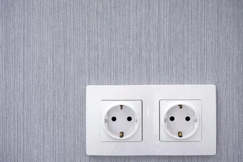 Two power sockets on gray wall. Stock Photos