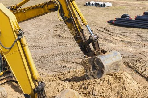 Two powerful excavators work at the same time on a construction site Stock Photos
