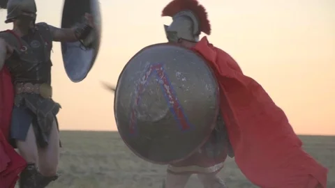 Two powerful Roman gladiators are fighting in the open field, evading each other 動画素材 78701405