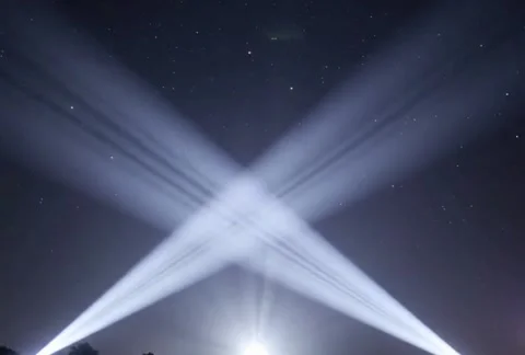 Two powerful searchlights illuminate starry night sky with dynamic light be.. Stock Footage 325164103