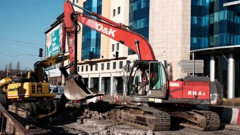 Two powerfull excavators work on a street in a city center. Stock Footage 124092607