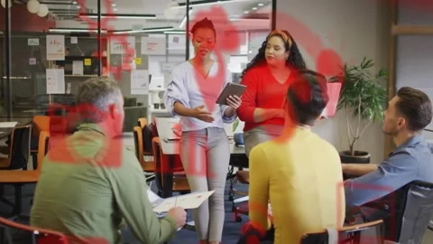 Two presenters referencing tablet, starting red overlay over group, guiding Stock Footage 329702172