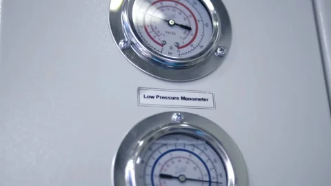 Two pressure gauges measuring high and low pressure in industrial equipment Stock Footage 340572589