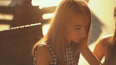 Two pretty girlfriends laughing while sitting in a bar outdoors Stock Footage 66261451