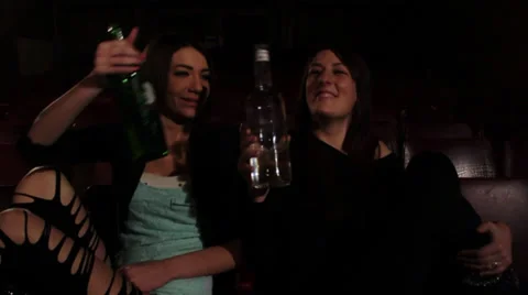 Two pretty girls drinking alcohol from a bottles Stock Footage 34366891