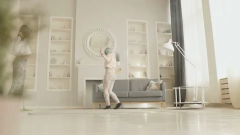 Two pretty girls having fun in a clean house. Homework concept Stock Footage 130602452