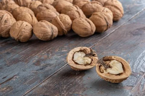 Two pretty halves of a ripe split walnut with a light, tasty core, a scatteri Fotos Stock