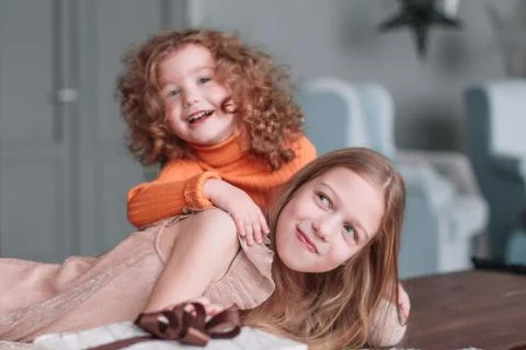 Two pretty sisters having fun on Christmas eve Stock Photos