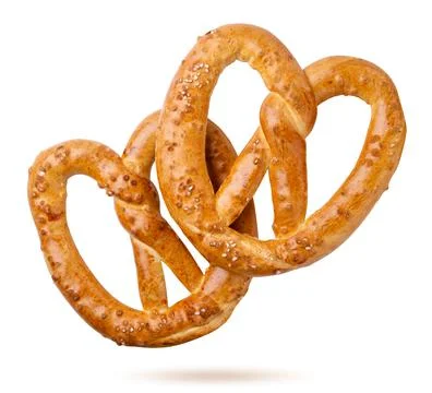 Two pretzels falling on a white background, bakery, oktoberfest. Isolated Stock Photos