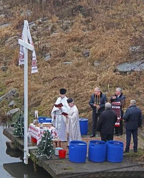 Two priests begin for the rite of Epiphany. Voron River in Tysmenytsia, Ivano Stock Photos