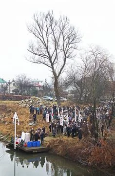 Two priests begin for the rite of Epiphany. Raven River in Tysmenytsia, Ivano Stock Photos